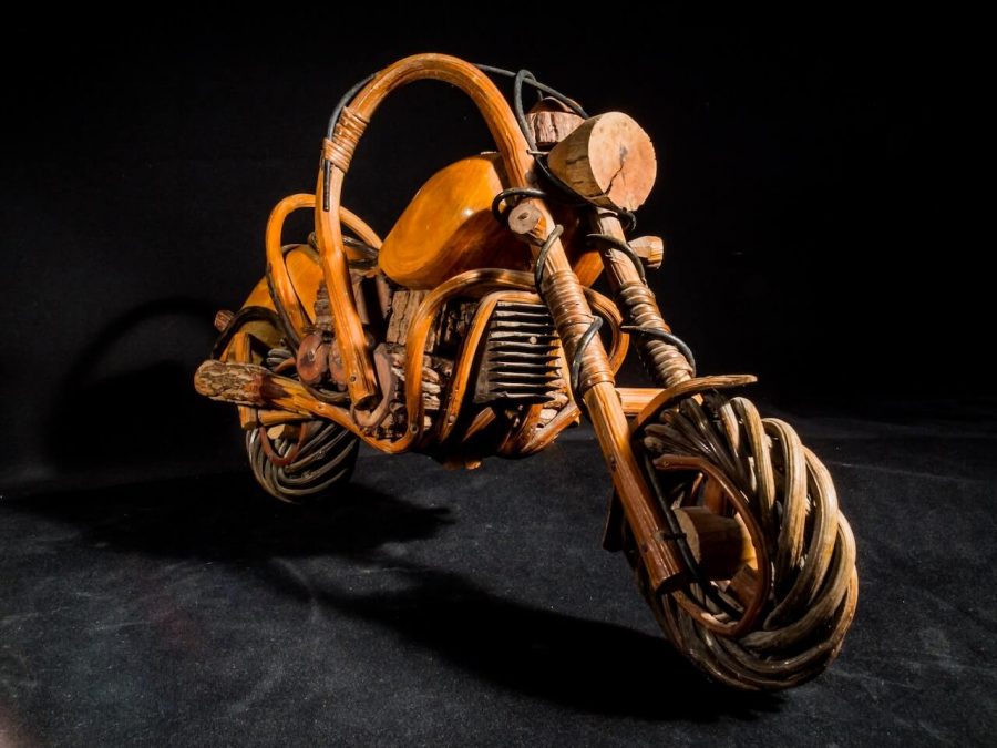 A unique wooden motorcycle, intricately crafted and resembling a real motorcycle, showcasing woodworking skills and creativity.